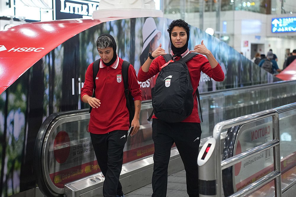 | Photo: AP/Azneal Ishak : Members of Iran's women's football team arrive at the Kuala Lumpur International Airport in Sepang, Malaysia.
