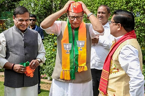 In this image posted on March 18, 2026, Assam Chief Minister Himanta Biswa Sarma, left, and BJP Assam president Dilip Saikia, right, welcome Nagaon MP Pradyut Bordoloi into the Bharatiya Janata Party, in New Delhi.