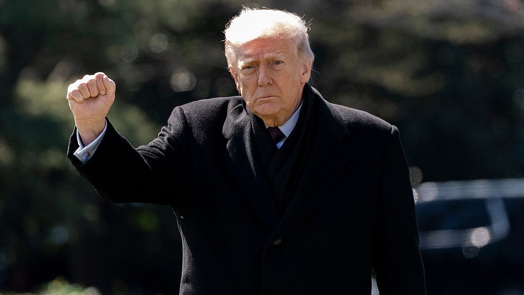 AP : US President Donald Trump pumps his fist as he walks to depart on Marine One from the South Lawn of the White House.