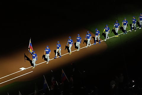 Venezuela enters the field at the start of the championship game of the World Baseball Classic against the United States, in Miami.