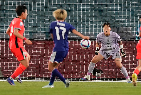 South Korea's goalkeeper Kim Min-jung, right, watches as a shot from Japan's Hinata Miyazawa comes towards her during the Women's Asian Cup semifinal soccer match between Japan and South Korea in Sydney.