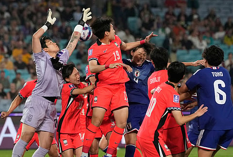 South Korea's goalkeeper Kim Min-jung punches the ball during the Women's Asian Cup semifinal soccer match between Japan and South Korea in Sydney.