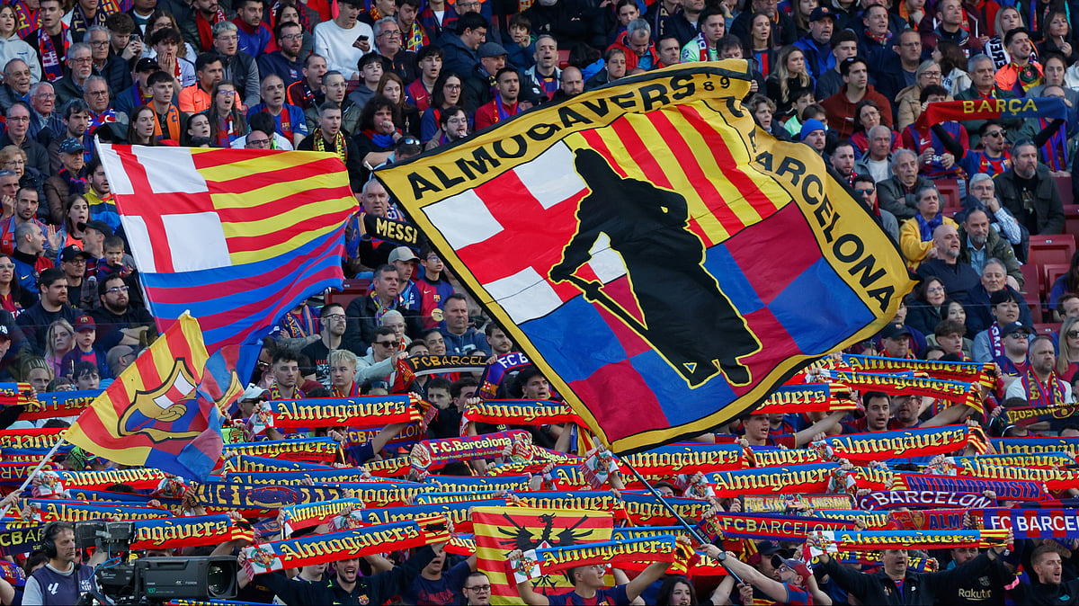 | Photo: AP/Joan Monfort : Fans of Barcelona's team cheer during the Spanish La Liga soccer match between Barcelona and Sevilla in Barcelona, Spain, Sunday, March 15, 2026.