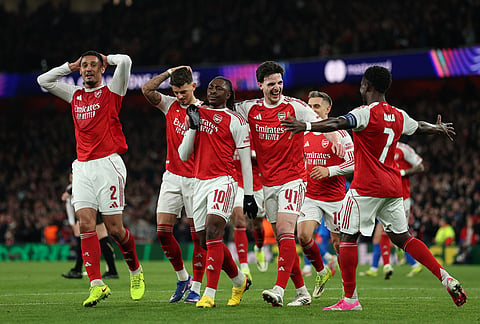 Arsenal's Eberechi Eze center, celebrates with teammates after scoring the opening goal during the second leg of the Champions League round of 16 soccer match between Arsenal and Bayer Leverkusen, in London.