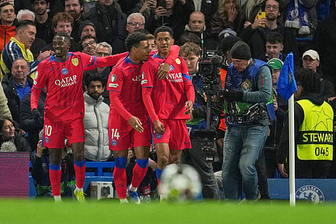 PSG's Senny Mayulu, centre, celebrates after scoring his side's third goal during the Champions League soccer match between Chelsea and Paris Saint-Germain in London, England.