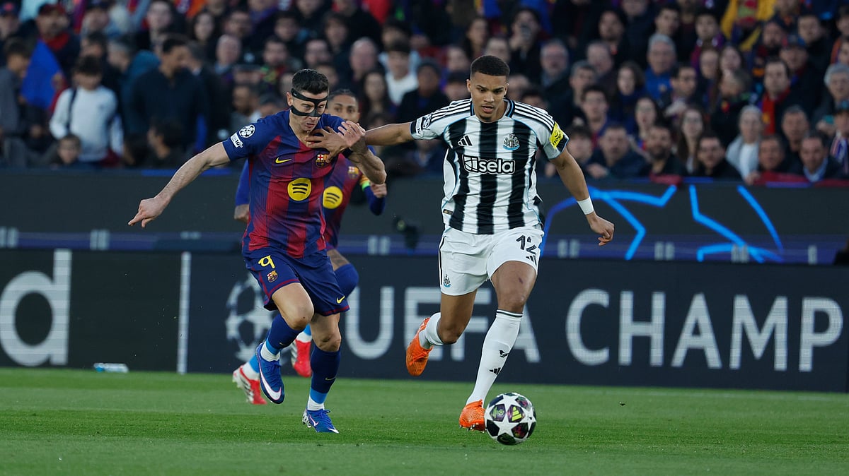 AP : Newcastle's Malick Thiaw, right, and Barcelona's Robert Lewandowski fight for the ball during the Champions League round of 16, second leg soccer match.
