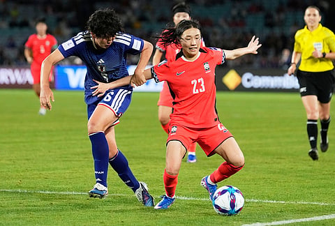Japan's Toko Koga, left, and South Korea's Kang Chae-rim during the Women's Asian Cup semifinal soccer match between Japan and South Korea in Sydney.
