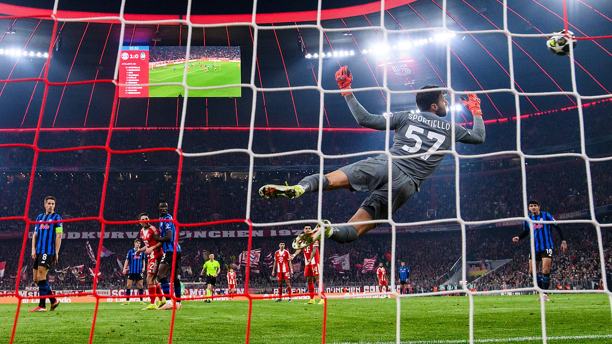 | Photo: AP/Tom Weller : Bayern Munich's Harry Kane scores to make it 2-0 against Atalanta Bergamo's Marco Sportiello, Wednesday, March 18, 2026, in Munich, Germany.