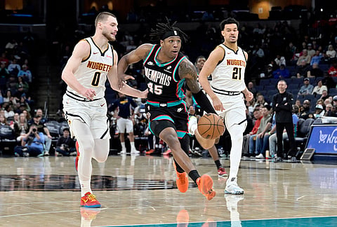 Memphis Grizzlies forward GG Jackson II (45) drives ahead of Denver Nuggets guard Christian Braun (0) and forward Spencer Jones (21) in the second half of an NBA basketball game in Memphis, Tennessee.