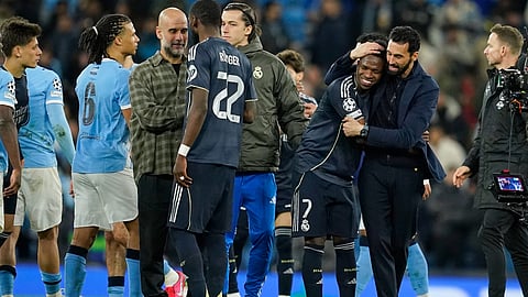 Manchester City's head coach Pep Guardiola talks to Real Madrid's Antonio Ruediger while Real Madrid's head coach Alvaro Arbeloa embraces Real Madrid's Vinicius Junior after the Champions League round of 16 second leg soccer match between Manchester City and Real Madrid in Manchester, Tuesday, March 17, 2026.