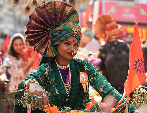 A woman dressed in traditional attire takes part in a bike procession on the occasion of the 'Gudhi Padwa' festival, in Mumbai, Maharashtra.
