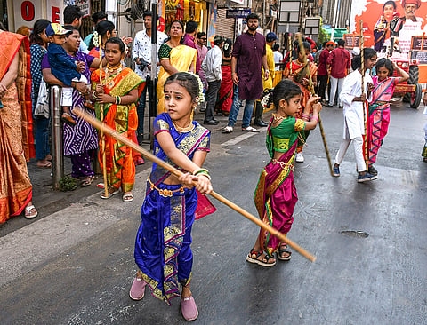 Children dressed in traditional attire perform during a procession on the occasion of the 'Gudhi Padwa' festival, in Pune, Maharashtra.
