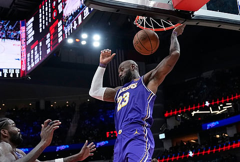 Los Angeles Lakers' LeBron James dunks the ball against the Houston Rockets during the second half of an NBA basketball game in Houston.