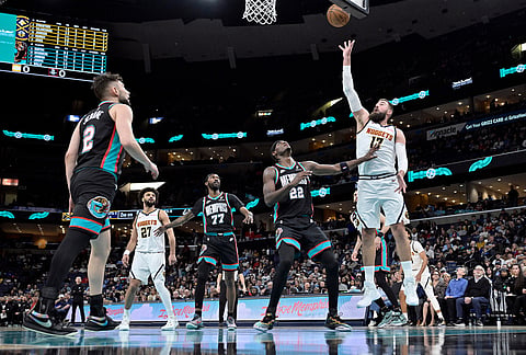 Denver Nuggets center Jonas Valanciunas (17) shoots against Memphis Grizzlies forward Taylor Hendricks (22) in the first half of an NBA basketball game in Memphis, Tennessee.