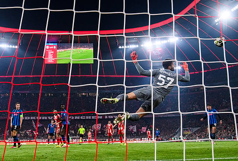 Bayern Munich's Harry Kane scores to make it 2-0 against Atalanta Bergamo's Marco Sportiello, in Munich, Germany.
