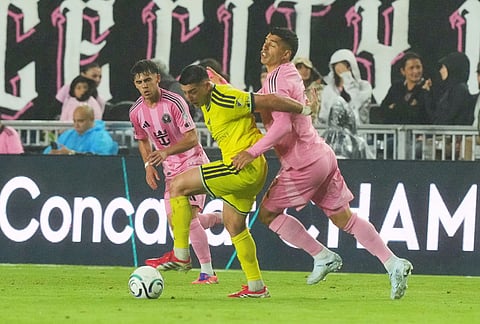 Nashville forward Cristian Espinoza and Inter Miami forward Luis Suárez go after the ball during the second half of a CONCACAF Champions Cup Round of 16 soccer match, in Fort Lauderdale, Florida.