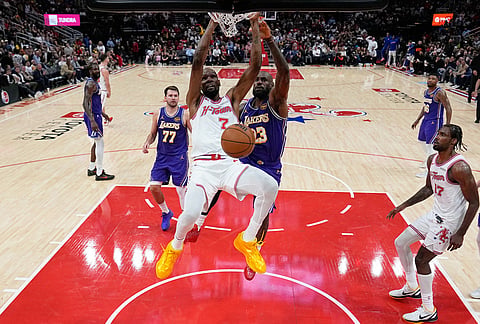 Houston Rockets' Kevin Durant (7) dunks the ball as Los Angeles Lakers' LeBron James (23) defends during the second half of an NBA basketball game in Houston.