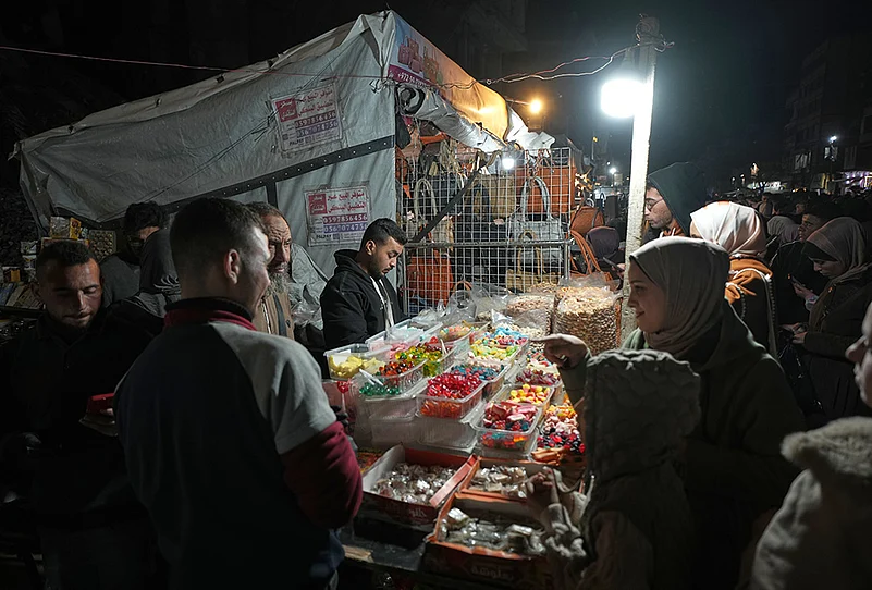 Eid al-Fitr 2026 in Gaza-Palestinians shop at a market