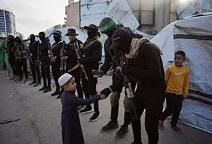 | Photo: AP/Abdel Kareem Hana : Palestinian militants from Hamas and Islamic Jihad greet people who gather for to Eid al-Fitr prayers in Gaza City, Friday, March 20, 2026.