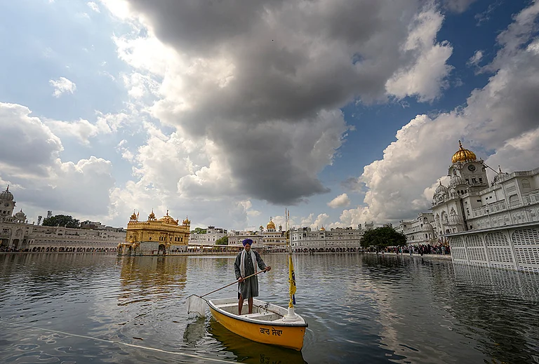 Dark clouds hover over the Golden Temple, in Amritsar. - | Photo: PTI/Shiva Sharma