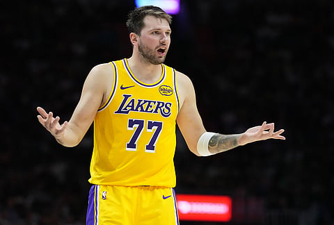 Los Angeles Lakers guard Luka Doncic (77) argues a call during the second half of an NBA basketball game against the Miami Heat, in Miami.
