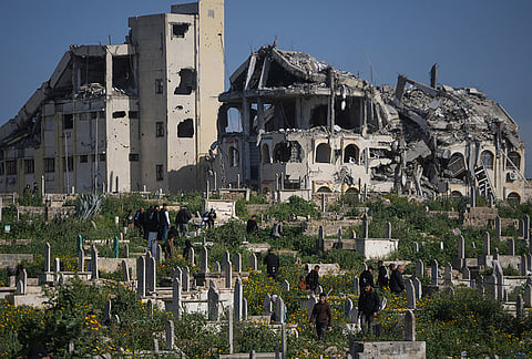 Palestinians visit the graves of their relatives who were killed in the Israel-Hamas war on the first day of the Muslim holiday of Eid al-Fitr in Gaza City, Friday, March 20, 2026. 