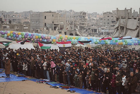 Palestinian Muslims offer Eid al-Fitr prayers amid the rubble of destroyed buildings in Jabaliya, Gaza Strip, Friday, March 20, 2026. 
