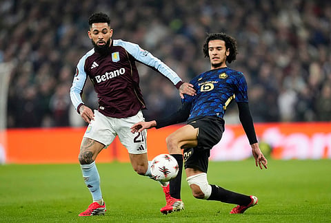 Lille's Ayyoub Bouaddi, right, and Aston Villa's Douglas Luiz, left, challenge for the ball during the Europa League round of sixteen second leg soccer match between Aston Villa and LOSC Lille in Birmingham, England.