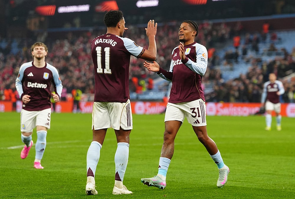 | Photo: David Davies/PA via AP : Aston Villa's Leon Bailey, right, celebrates with his teammate Ollie Watkins after scoring his side's second goal during the Europa League round of sixteen second leg soccer match between Aston Villa and LOSC Lille in Birmingham, England.