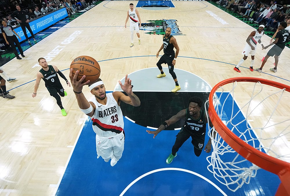 | Photo: AP/Abbie Parr : Portland Trail Blazers forward Toumani Camara (33) shoots during the first half of an NBA basketball game against the Minnesota Timberwolves in Minneapolis. 