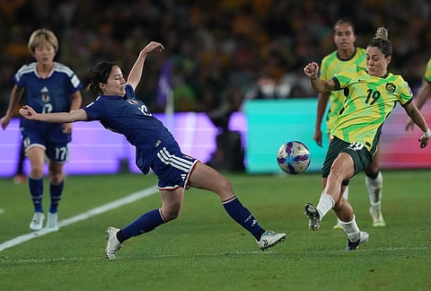 Japan's Riko Ueki is challenged by Australia's Winonah Heatley during the Women's Asian Cup soccer final between Japan and Australia in Sydney.