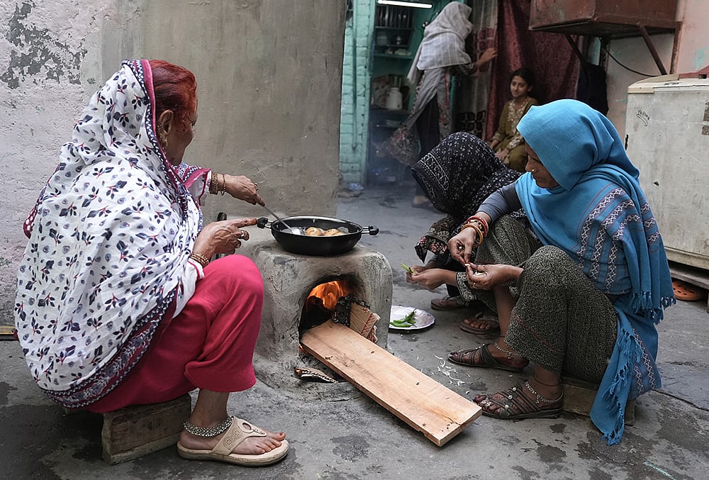 Amid LPG cylinder shortage, people resort to cooking using traditional methods 