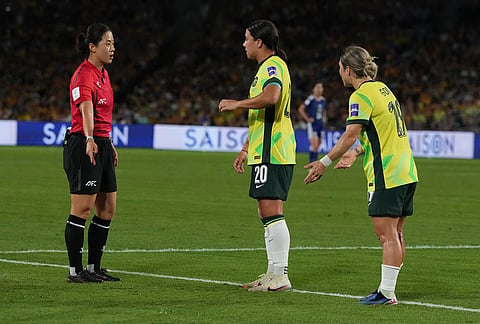 Australia's Sam Kerr, center, argues with referee during the Women's Asian Cup soccer final between Japan and Australia in Sydney.