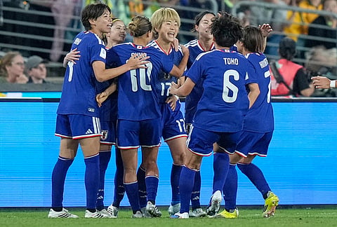 Japan's Maika Hamano, center, celebrates with teammates after scoring the opening goal during the Women's Asian Cup soccer final between Japan and Australia in Sydney.
