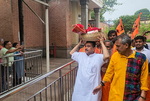 BJP candidate for Bhabanipur and Nandigram Assembly constituencies Suvendu Adhikari offers prayers, at Kalighat Kali Temple in Kolkata. 