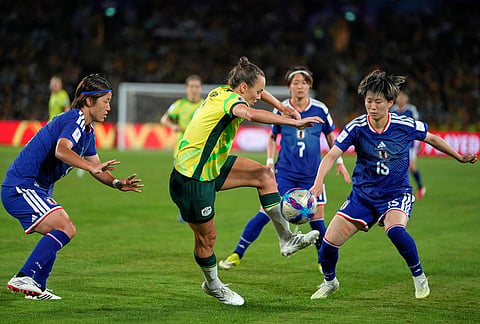 Australia's Caitlin Foord, center, is challenged by Japan's Hana Takahashi, left, and Japan's Aoba Fujino during the Women's Asian Cup soccer final between Japan and Australia in Sydney.