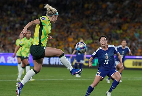 Australia's Ellie Carpenter, left, controls the ball during the Women's Asian Cup soccer final between Japan and Australia in Sydney.