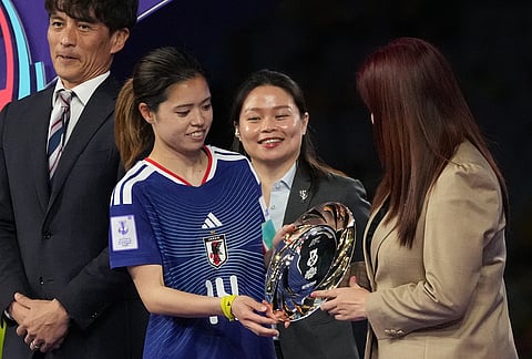 Japan's Yui Hasegawa receives the player of the tournament award after the Women's Asian Cup soccer final between Japan and Australia in Sydney.