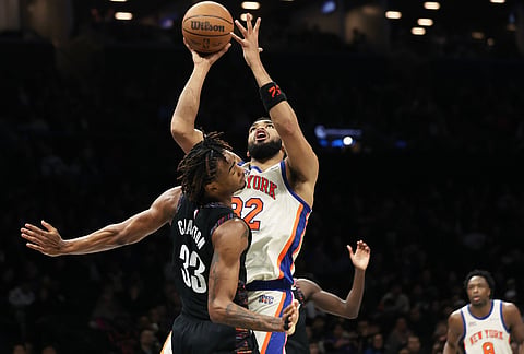 New York Knicks center Karl-Anthony Towns (32) shoots over Brooklyn Nets center Nic Claxton (33) during the second half of an NBA basketball game in New York.