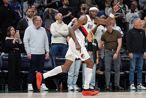 Portland Trail Blazers forward Jerami Grant (9) celebrates after making a 3-point shot during the second half of an NBA basketball game against the Minnesota Timberwolves, in Minneapolis.