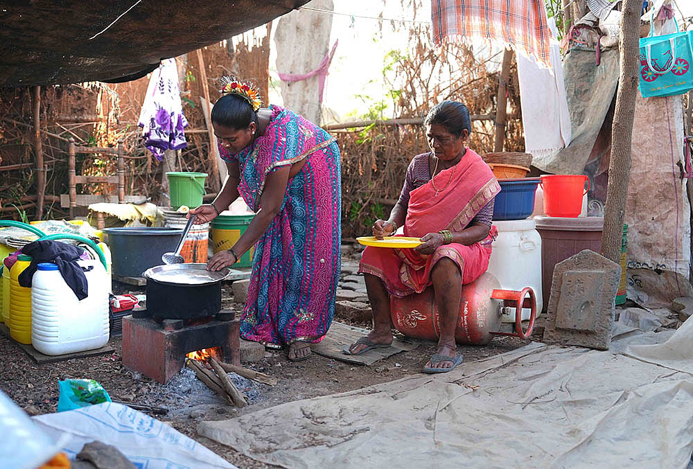 Nanu Bai Sohale (62) prepares food on a traditional wood-fired stove