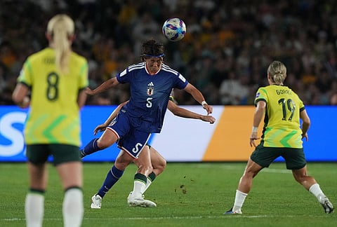 Australia's Jamilla Rankin, center, tries to control the ball during the Women's Asian Cup soccer final between Japan and Australia in Sydney.