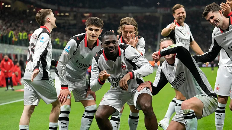 AC Milan's Youssouf Fofana, center, celebrates scoring his side's 3rd goal with teammates during the Serie A soccer match between AC Milan and Torino, in Milan, Italy, Saturday, March 21, 2026. - | Photo: AP/Luca Bruno