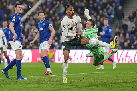 Chelsea's Joao Pedro, centre, makes an attempt to score past Everton's goalkeeper Jordan Pickford during the English Premier League soccer match between Everton and Chelsea in Liverpool, England.