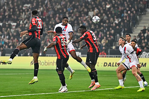 PSG's Willian Pacho, center, heads the ball during the French League One soccer match between Nice and Paris Saint-Germain in Nice, France.
