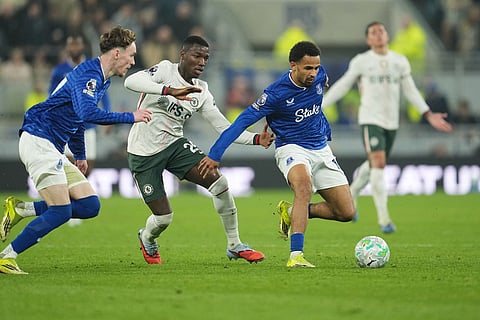 Chelsea's Moises Caicedo, centre, challenges for the ball with Everton's James Garner, left, and Everton's Iliman Ndiaye during the English Premier League soccer match between Everton and Chelsea in Liverpool, England.
