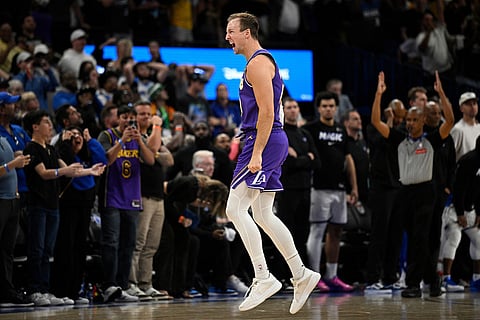 Los Angeles Lakers guard Luke Kennard celebrates after his winning basket during the second half of an NBA basketball game against the Orlando Magic, Saturday, March 21, 2026, in Orlando, Fla. ()