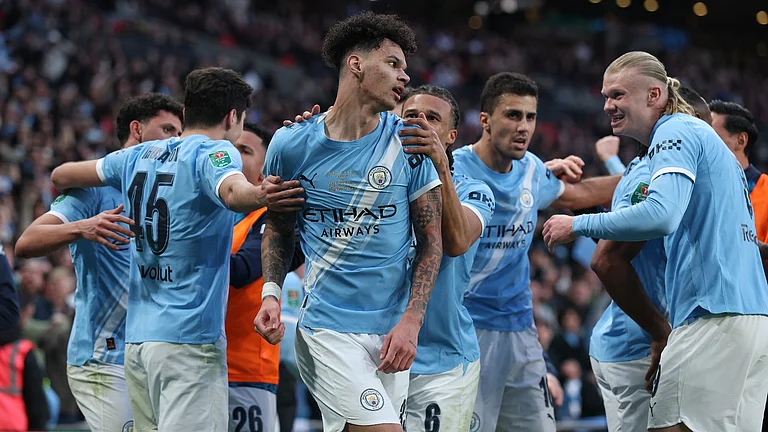 Manchester City's Nico O'Reilly, center, celebrates with teammates after scoring the opening goal during the English League Cup final soccer match between Arsenal and Manchester City in London, Sunday, March 22, 2026. - AP Photo