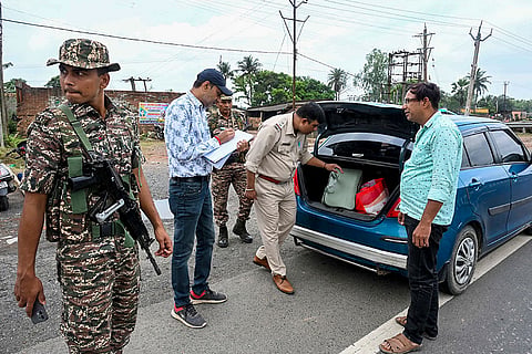 Security personnel conduct naka checking of vehicles along National Highway 12 (NH 12) as part of election security measures, in Malda.