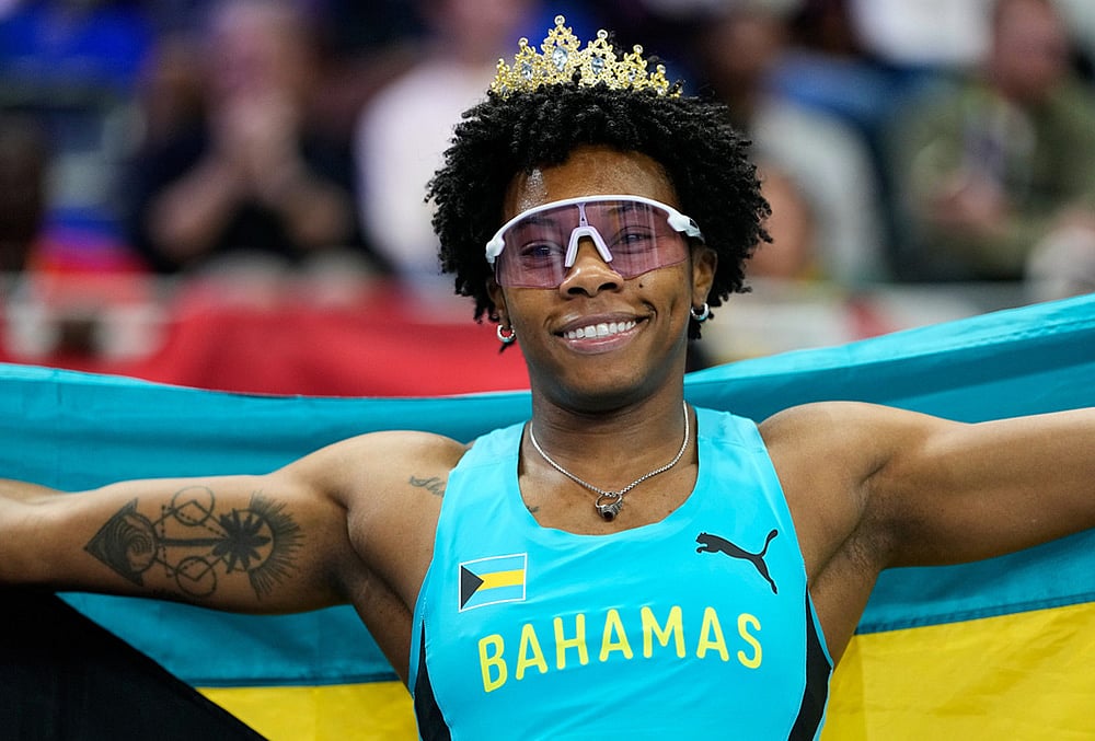 | Photo: AP/Matthias Schrader : Devynne Charlton, of Bahamas, poses after winning the gold medal in the women's 60 meters hurdles final at the World Athletics Indoor Championships in Torun, Poland.